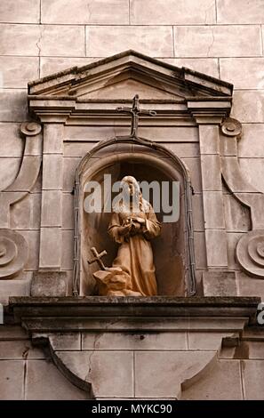 Religious sculpture of the virgin Maria in the wall of a Christian church Stock Photo