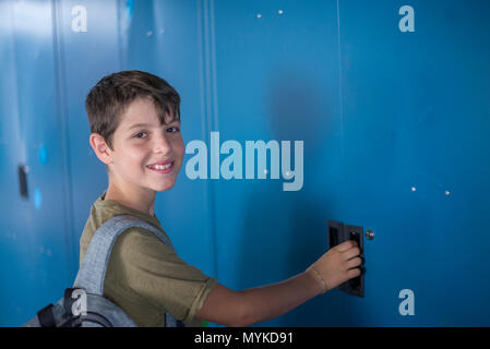 Student standing in front of the blue school lockers Stock Photo