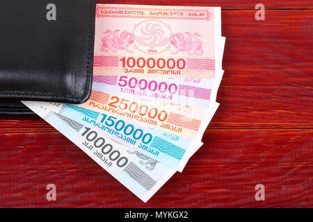 Old Georgian money in the black wallet Stock Photo