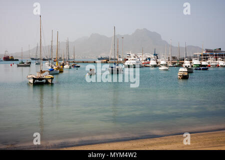 MINDELO, CAPE VERDE - DECEMBER 07, 2015: Boats and yachts in Marina of Sao Vicente island. Visible Face Mountian Stock Photo