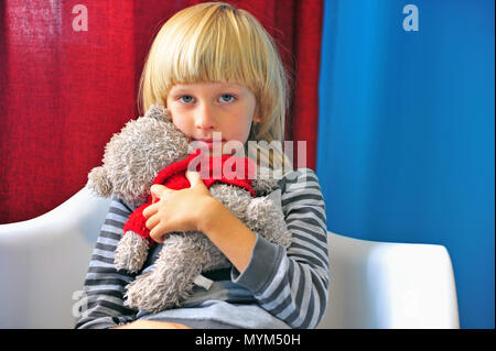 Cute little boy hugging with teddy bear Stock Photo