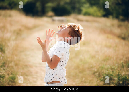 Boy is spinning fidget spinner on his nose Stock Photo