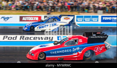 Top Fuel funny car drag racing at Santa Pod Raceway. Kevin Chapman Ford Mustang nearside V Kevin Kent Ford Mustang far side. Stock Photo