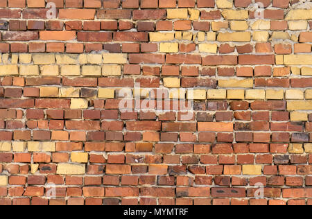 Wall with red and yellow bricks Stock Photo