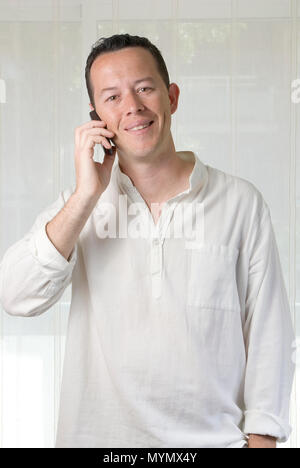 A young man calling a friend with his cellular Stock Photo