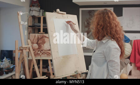 Female student working on a new painting in art class Stock Photo