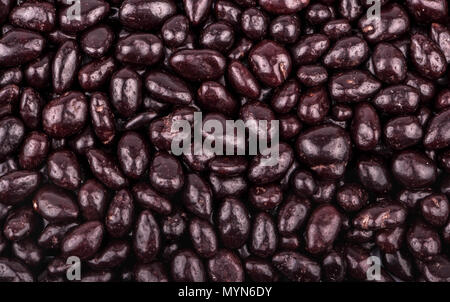 Background of the plurality of scattered sunflower seeds in chocolate closeup Stock Photo