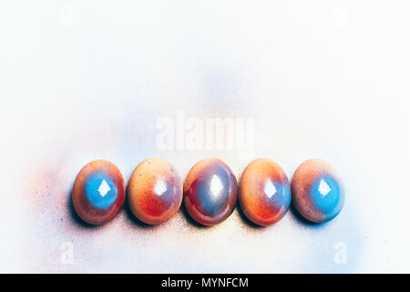 Five colorful shiny eggs on a white background. Easter egg. Handpainting. Stock Photo
