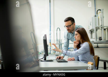 Young students presenting e-learning service in classroom Stock Photo