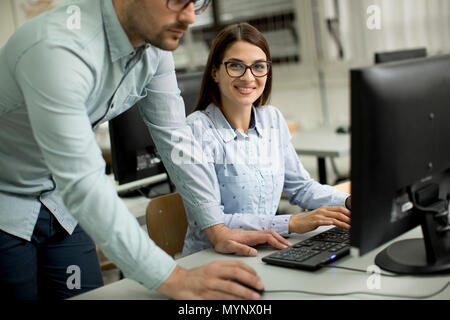 Young students presenting e-learning service in classroom Stock Photo