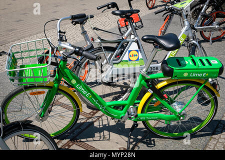Berlin, Germany - june 2018: Many electric bicycles  of public bike sharing company LimeBike in Berlin, Germany Stock Photo