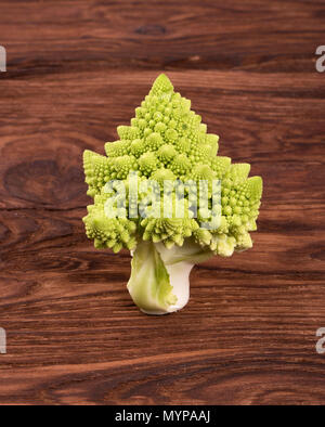 Sprig of fresh Romanesco cabbage on a wooden background Stock Photo