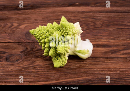 Sprig of fresh green cabbage Romanesco on a wooden background Stock Photo