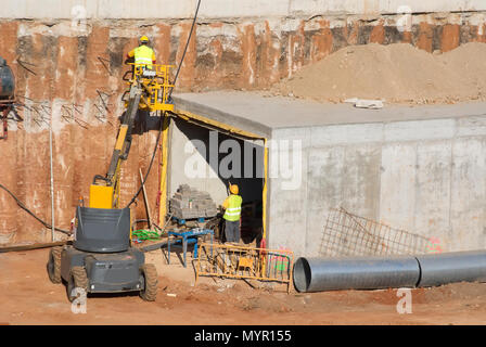 Workers working outdoors in a constrution Stock Photo