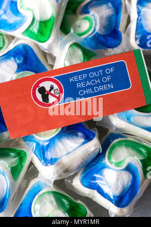 Colorful laundry detergent pods with 'keep out of reach of children' warning, USA Stock Photo