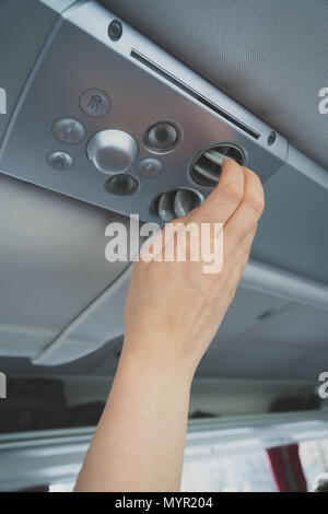 Woman checking air-conditioning system in bus. Stock Photo