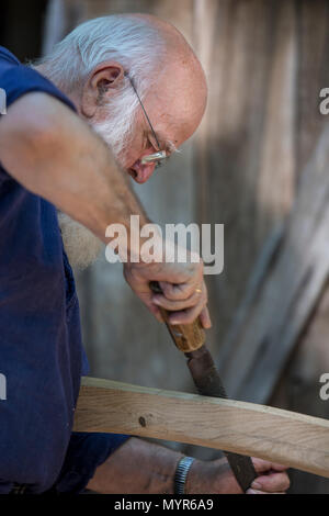 Carpenter in old fashioned clothing at work in the Open Air Museum, Arnhem, the Netherlands Stock Photo