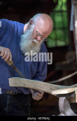 Carpenter in old fashioned clothing at work in the Open Air Museum, Arnhem, the Netherlands Stock Photo