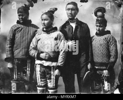 .  English: An Inuit group in Inuit and European clothes. An Inuit man dressed in European clothes with three Inuit women in traditional clothing. The upper garment of the woman on the right may be knitted wool (like the ones worn by the Danish official and his sons in G4263) and may represent a fusion between Inuit and Nordic clothing. The Inglefield Album held by the Royal Archives records noted that the people in the photograph are (l-r) Mother, Daughter, Fiance, and Sister-in-Law. An Inuit group in Inuit and Eurpoean clothes.  . 8-17 June 1854. Captain Edward Augustus Inglefield 351 An Inu Stock Photo