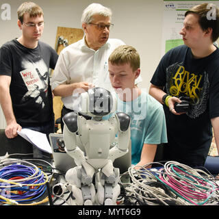 06 June 2018, Leipzig, Germany: In the robotic laboratory of the University of Applied Sciences HTWK in Leipzig, the computer science students Marvin Jenkel and Daniel Weiss of the Nao team inspect the running and real-time capability of the football robots before participating in the World Cup «RoboCub 2018» in Montreal (18.-22.06.2018). The student team is traveling to Canada with nine robot footballers and hoping for a football title at the World Cup of Intelligent Robots. Photo: Waltraud Grubitzsch/dpa-Zentralbild Stock Photo
