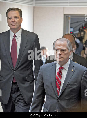 From left, FBI Director James Comey, CIA Director John Brennan, and ...