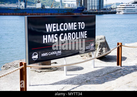 Welcome sign for HMS Caroline, a restored World War 1 battleship moored in Titanic Quarter, Belfast and the last survivor of the Battle of Jutland Stock Photo