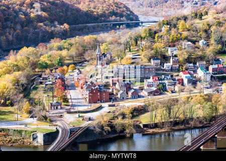 Harper's Ferry overlook closeup of cityscape with colorful orange yellow foliage fall autumn forest with small village town by river in West Virginia, Stock Photo