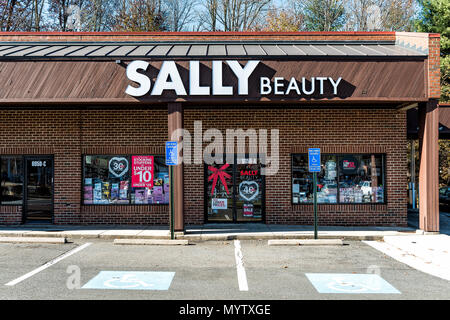 Burke, USA - November 24, 2017: Sally Beauty Supply store in plaza shopping center strip mall sign in Virginia with parking lot, shops Stock Photo