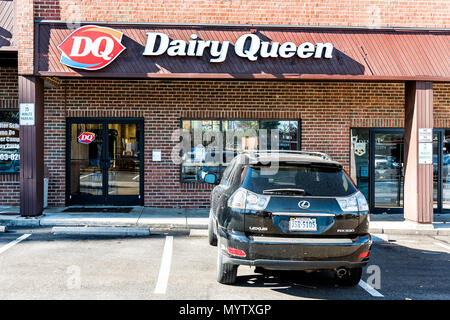 Burke, USA - November 24, 2017: Dairy Queen fast food restaurant ice cream store in plaza shopping center strip mall sign in Virginia with parking lot Stock Photo