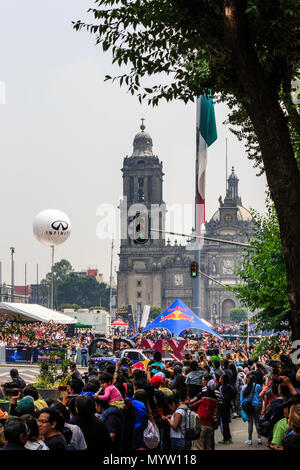 Mexico City, Mexico - June 27, 2015: Zocalo Square full of spectators watching the Showrun. With the Mexico City Metropolitan Cathedral as background, at the Infiniti Red Bull Racing F1 Showrun. Stock Photo