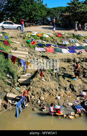 Local people washing clothes in Ayeyarwady river, Mandalay, Myanmar. Ayeyarwady river is the largest river in Myanmar. Stock Photo