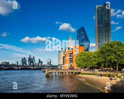 Thames Beach - people play and walk on the sandy beach on the River Thames on London's Southbank - London Tourism Stock Photo