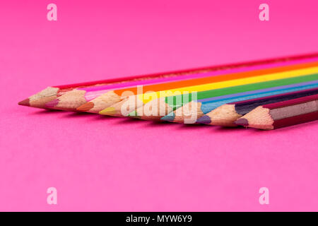 Colored wooden pencils on pink background and space. Art and education concept. Close up, selective focus Stock Photo