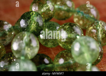 Macro image of natural mineral rock specimen in form of round bead from green jade gemstone Stock Photo