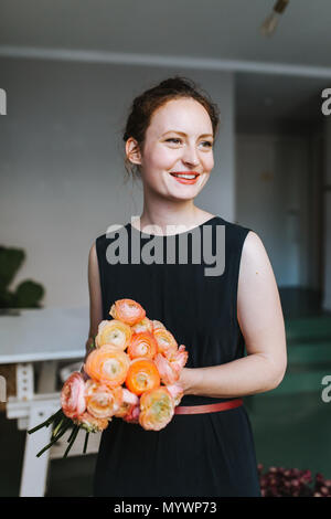 florist holding a wonderful bouquet of beautiful colorful flowers in her hands Stock Photo