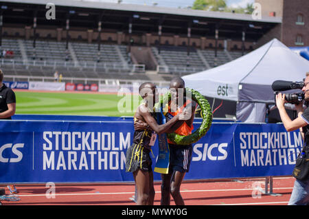 Stockholm, Sweden - 2 June 2018. The winner of the 40th Stockholm marathon, Lawi Kiptui from Kenya, hugs the runner-up, Dominic Kimwetich Kangor also  Stock Photo