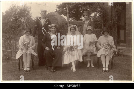 . Portrait photo of Campion-King wedding at Swindon, Wiltshire, England in 1929. From a postcard deposited at Swindon Record Office and scanned and uploaded by them to Flickr. The photographer was Fred C. Palmer of Tower Studio, Herne Bay, Kent ca.1905-1916, and of 6 Cromwell Street, Swindon ca.1920-1936. He is believed to have died 1936-1939. Points of interest: The sailor-groom is from the aircraft carrier HMS Eagle which was serving in the Mediterranean Fleet in 1929. In the previous year his captain and commander had been tried on board ship at Gibraltar for the Royal Oak Mutiny. The ship' Stock Photo