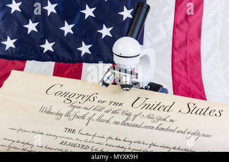 Winneconne - 11 May 2018: The  United States constitution is under the microscope with the American flag Stock Photo