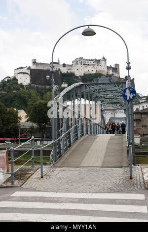 The Mozartsteg, a footbridge that appears in the Sound of Music movie, with the Hohensalzburg fortress in the background, in Salzburg, Austria. Stock Photo