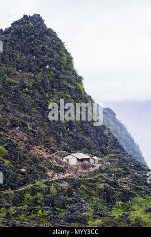 A remote house built from stone on the side of a mountain in Ha Giang Province, Northern Vietnam Stock Photo