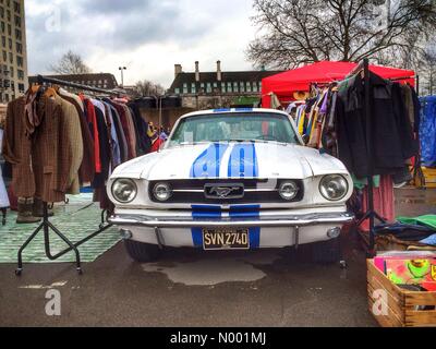 London, UK. 15th Mar, 2015. A Ford Mustang amongst rails of vintage clothes at the Classic Car Boot sale at the South Bank Centre, London, England. Sunday 15th March 2015. Credit:  Jamie Gladden / StockimoNews/Alamy Live News Stock Photo