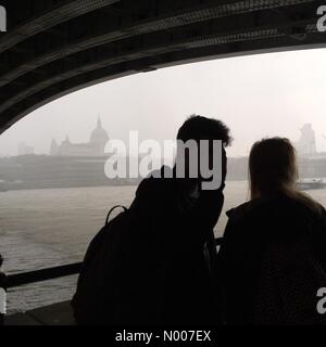 London, UK. 08th June, 2016. couple takes shelter from heavy rain in Central London this afternoon Credit:  Emin Ozkan / StockimoNews/Alamy Live News Stock Photo