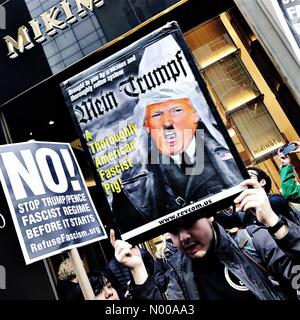 E 57th St, New York, New York, USA. 11th Jan, 2017. A protester holds up a banner outside Trump Tower in New York City as President Elect Donald Trump gives a press conference inside, his first since winning the 2016 US election. © Andy Buchanan1/StockimoNews/Alamy Live News Stock Photo