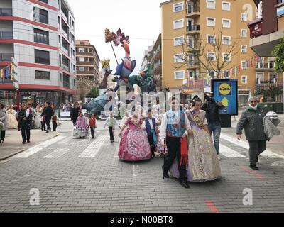 Dénia, Alicante, Spain. 17th Mar, 2017. Fallas in Denia, Spain. Falla members wearing traditional costumes walk past a large Falla monument in the town. The Falla monument will be burnt on the last day of the fiesta. Credit: Scott Ramsey/StockimoNews/Alamy Live News Stock Photo