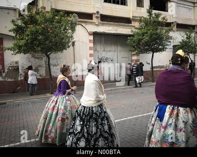 Dénia, Alicante, Spain. 17th Mar, 2017. Fallas in Denia, Spain. Fallas members, called falleros, wearing traditional costumes walk past orange trees in the town. Credit: Scott Ramsey/StockimoNews/Alamy Live News Stock Photo