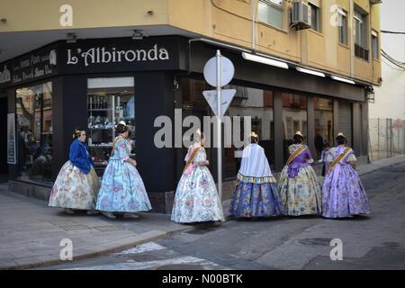 Dénia, Alicante, Spain. 17th Mar, 2017. Fallas in Denia, Spain. Fallas members, called falleros, wearing traditional costumes walk past a bar in the town. Credit: Scott Ramsey / StockimoNews/Alamy Live News Stock Photo