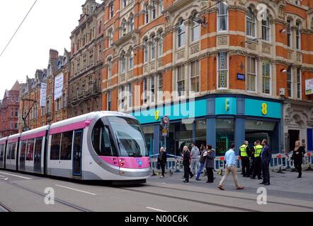 Birmingham, UK. 28th March, 2017. A pink Birmingham tram, passes a safety cordon on Corporation Street, where roof tiles had earlier talked to the pavement. Credit: Gary Parker / StockimoNews/Alamy Live News Stock Photo