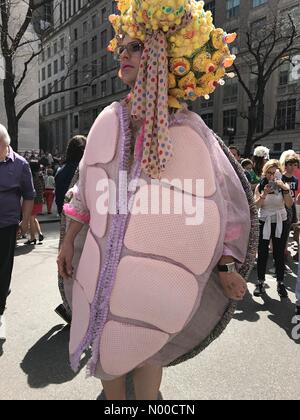 5th Ave, New York, New York, USA. 16th Apr, 2017. A man in a turtle costume and decorated headpiece poses for pictures on Fifth Avenue in New York City during the annual Easter Bonnet Parade, April 27, 2017. Credit: TD Dolci/StockimoNews/Alamy Live News Stock Photo