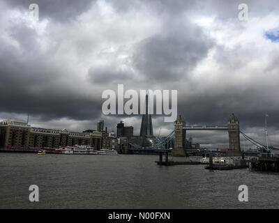 London, UK. 20th July 2017. Grey clouds are seen above the London Shard and Tower Bridge on the River Thames in London today during hot and humid summer weather. Credit: Vickie Flores/StockimoNews/Alamy Live News Stock Photo