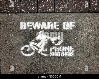 London, UK. 08th Aug, 2017. Beware of phone snatchers on mopeds pavement stencil London Credit: Tim Cordell/StockimoNews/Alamy Live News Stock Photo